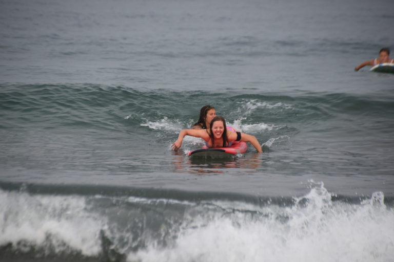 Paddling for a wave in surf lesson